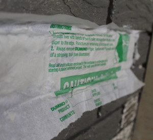 testing Dumont's Peel Away paint remover on the brick fireplace